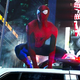 Andrew Garfield's Spider-Man crouches atop a police car in Times Square, in a scene from The Amazing Spider-Man 2.